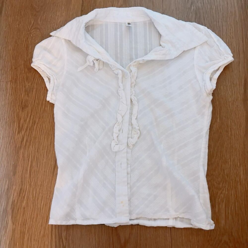 White blouse with subtle diagonal stripes and ruffles
